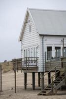 Beach house on stilts by the sea photo