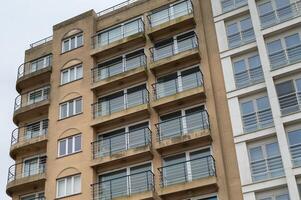 large narrow house facades with windows and balconies photo