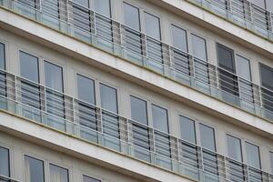 large narrow house facades with windows and balconies photo