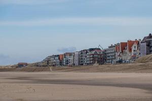 the coast at low tide with beach in the early morning of De Haan, Belgium photo