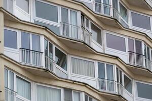 large narrow house facades with windows and balconies photo