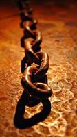 AI generated Close-up of a rusty metal chain on textured surface photo