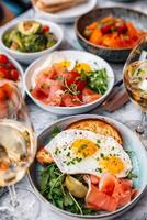 AI generated Gourmet breakfast with eggs, salmon, and fresh vegetables photo