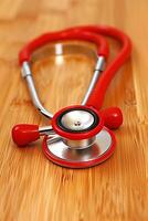 AI generated Red stethoscope on wooden background for medical concepts photo