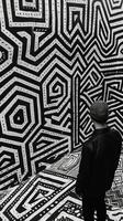 AI generated Man in front of geometric pattern wall in black and white photo
