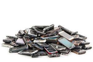 AI generated Pile of old mobile phone. Heap of the different smartphones isolated on white background. photo