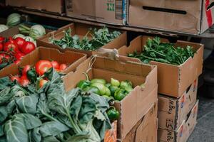 AI generated Fresh vegetables in cardboard boxes on market. photo