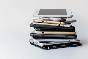 AI generated A pile of different smartphones isolated on a white background. photo