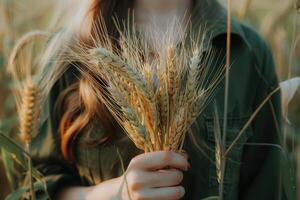 AI generated Woman holds an ear of golden wheat. Rural scene. photo