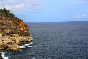 rock formation and the blue sea. photo