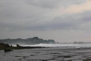 dramatic photo of beach and rough wave