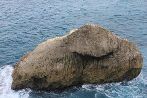 high angle view of rock formation at the ocean. photo