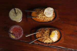 simple lunch pack, including noodles and beverages. high angle view, flat lay composition. photo