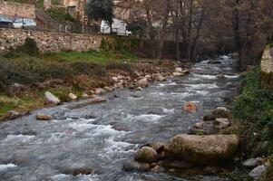 fluir de agua desde un río paso mediante un pueblo foto