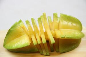 slices of starfruit well arranged on wooden cutting board photo