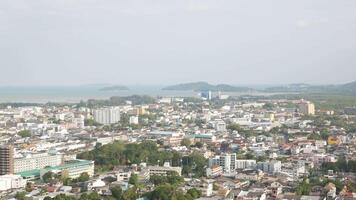 aerial view of phuket town city with background of bay and beach and mountain hill range under sunny sunshine sky daytime video