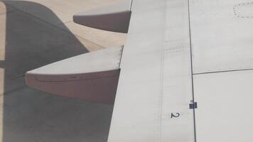 view through airplane window to the wing while aircraft push back from gate ready to travel video