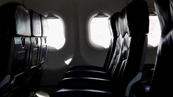 view to the airplane window with empty seat in daytime inside airplane cabin video