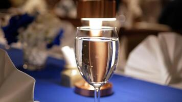 view to the classy banquet table for celebration at banquet hall in night time with well prepared setting napkin for dinner time video