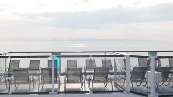 empty lounge chairs on sundecks of the cruise ship while cruising in the international open sea in asia in summer holiday vacation time. Sun lounge chair on balcony deck of cruise ship video