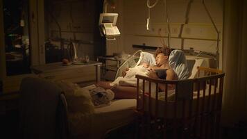 Black Woman with Curly Hair Resting in Delivery Room With Infant Child video