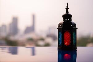 Lantern with dusk sky and blurred city background for the Muslim feast of the holy month of Ramadan Kareem. photo
