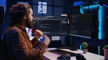 Software technician feeling relieved after removing all code bugs, having burst of emotion. Smiling IT professional celebrating after solving script errors, shaking fist from happiness, camera B video