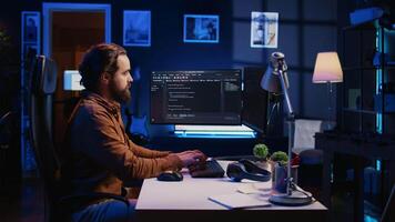 Programmer developing code on computer screen while in personal office using java programming languages. IT admin working with software tool, fixing database errors while working from home, camera B video