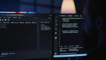 Software engineer writes complex binary code scripts on computer, close up. Teleworking IT specialist in home office using programming to safeguard consumer data, handheld camera shot, camera A video