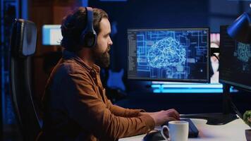 Developer updating artificial intelligence neural networks, drinking coffee and listening music in personal office. IT expert enjoying hot beverage and audio podcasts while writing AI code, camera A video