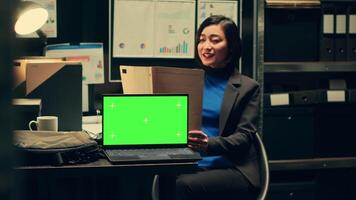 Forensic expert examines case evidence next to greenscreen on pc display, reading federal information in police archive. Woman detective uses classified files and isolated mockup template. Camera A. video