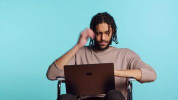 middle eastern man composing email, typing on laptop keyboard, struggling to think of what to write. BIPOC person sending mail online, brainstorming message idea, studio background, camera A video