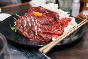 horse meat pieces or Japanese Baniku. Sakura niku ready for hot pot cooking menu. Premium meat and famous food in Matsumoto city, Nagano Prefecture, Japan photo