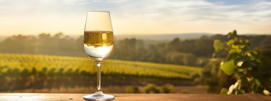 AI generated a glass of white wine sitting on a table in front of vineyards photo