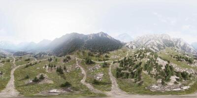 An aerial view of a mountain range with a road going through it video