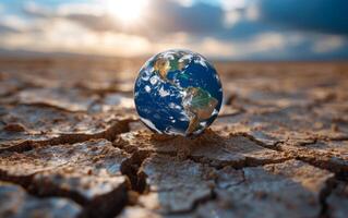 AI generated Mini Earth Model on Cracked Ground Signifying Climate Modification photo