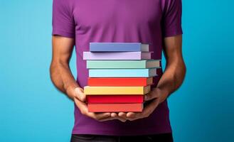 AI generated man holding stacked up book against blue background photo