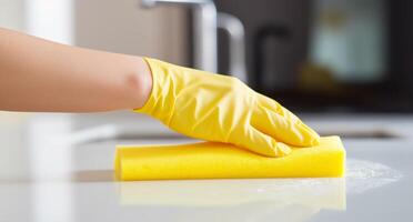 AI generated woman washing kitchen counter with sponge in yellow rubber gloves photo