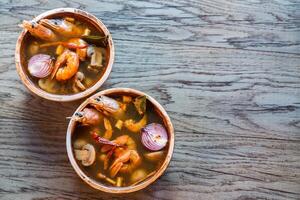 Two bowls of thai tom yum soup photo