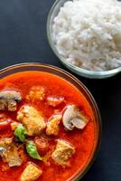 Thai red chicken curry with white rice photo