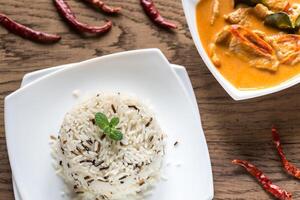 Thai panang curry with bowl of white and wild rice photo