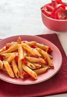 Penne with tomato sauce and fresh red pepper photo