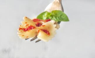 Piece of butterfly pasta on a fork photo
