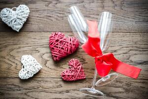 Two flutes with retro cane hearts on the wooden background photo