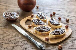 Slices of baguette with chocolate cream photo