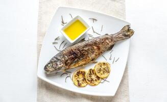 Grilled trout with lemon and rosemary photo