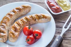 Grilled sausages with tomato and mustard sauce photo