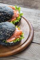 Black sandwich with salmon photo