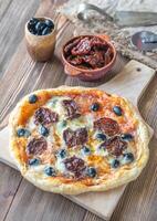 Pizza with sun-dried tomatoes and mozzarella photo