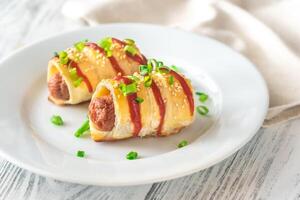 Sausage rolls on the white plate photo